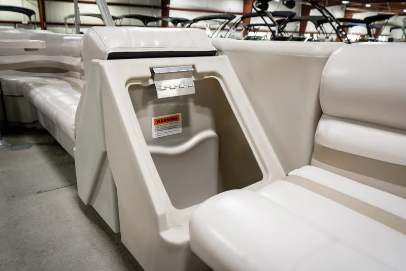 Slide: The Image of 1992 Harris FloteBote 240 Super Sunliner interior seating with storage compartment. - 24