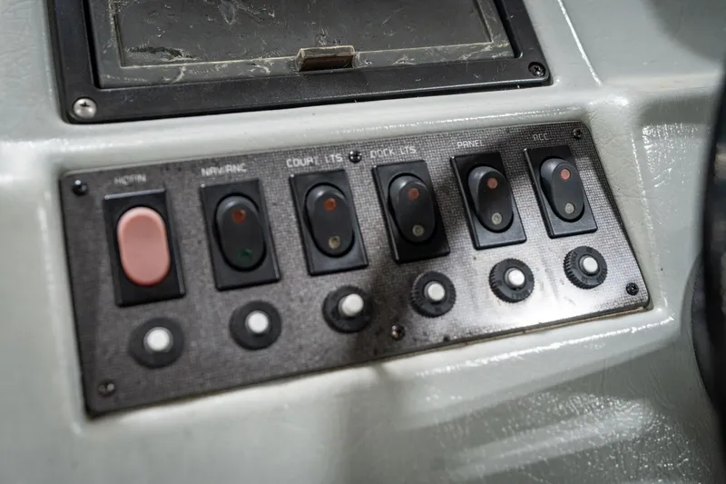 Slide: The Image of Control panel of a 1992 Harris FloteBote 240 Super Sunliner boat with various switches. - 33