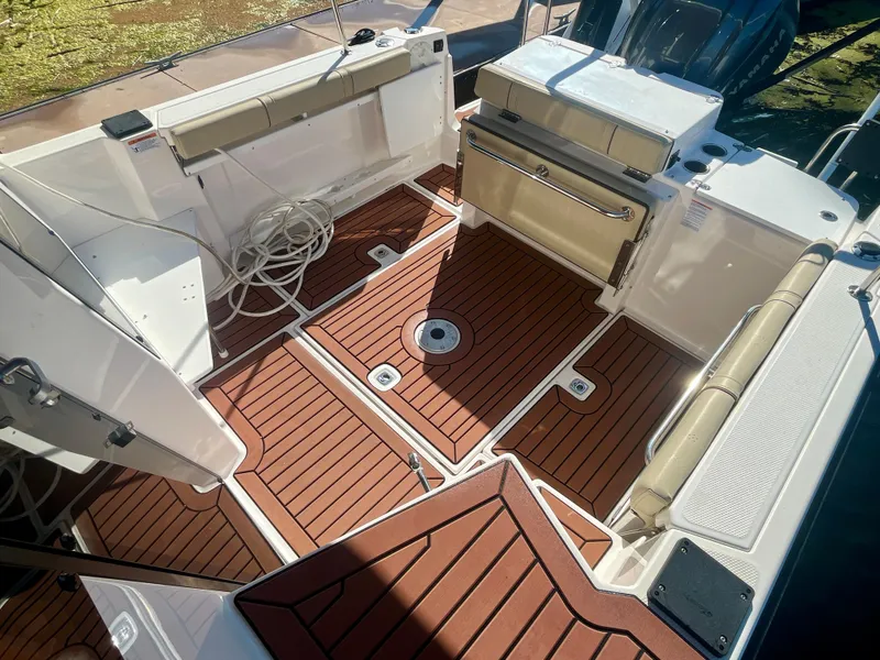 Slide: The Image of 2023 Ranger Tugs R-27 boat deck with teak flooring and seating. - 11