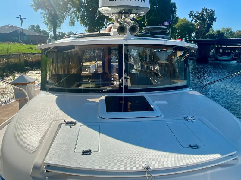 Slide: The Image of 2023 Ranger Tugs R-27 boat docked, showcasing front deck and cabin windows. - 6