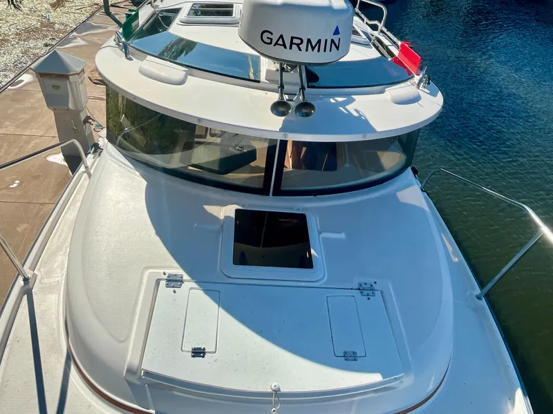 Slide: The Image of 2023 Ranger Tugs R-27 boat with Garmin radar, docked by the water. - 7