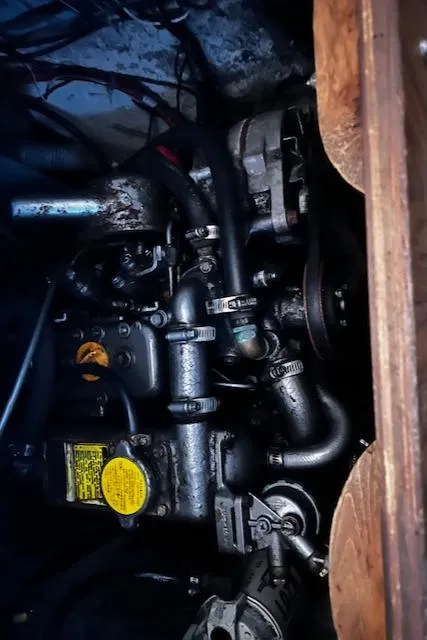 Slide: The Image of Engine compartment of a 1977 Cape Dory Sloop, showcasing mechanical components and hoses. - 10