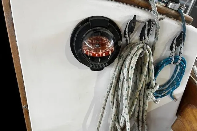 Slide: The Image of Compass and ropes on a 1977 Cape Dory Sloop sailboat. - 12