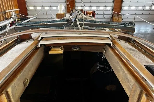 Slide: The Image of 1977 Cape Dory Sloop interior view with wooden details and nautical equipment. - 13