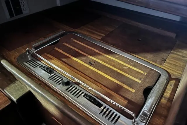 Slide: The Image of 1977 Cape Dory Sloop interior with wooden countertop and built-in stove. - 6