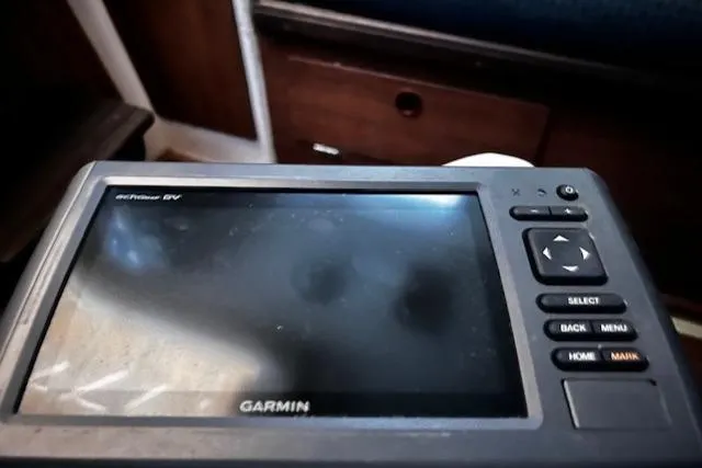 Slide: The Image of Garmin GPS device on a 1977 Cape Dory Sloop, showing navigation controls. - 8