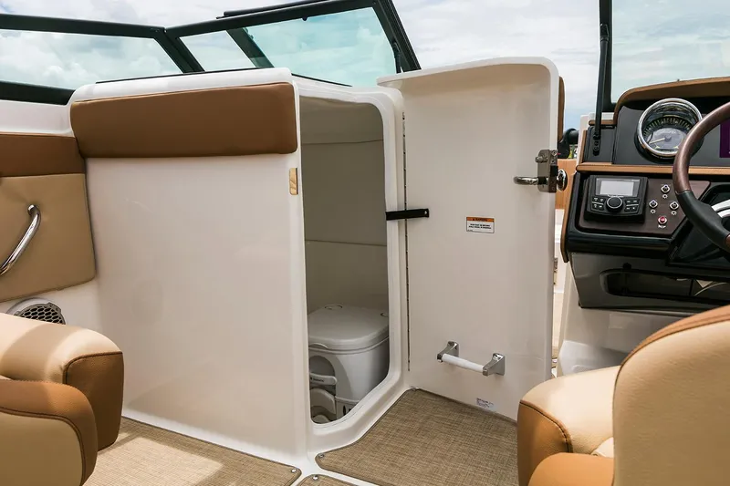 Slide: The Image of Manufacturer Provided Image: 2018 Sea Ray SPX 230 OB boat interior with open bathroom door. - 7