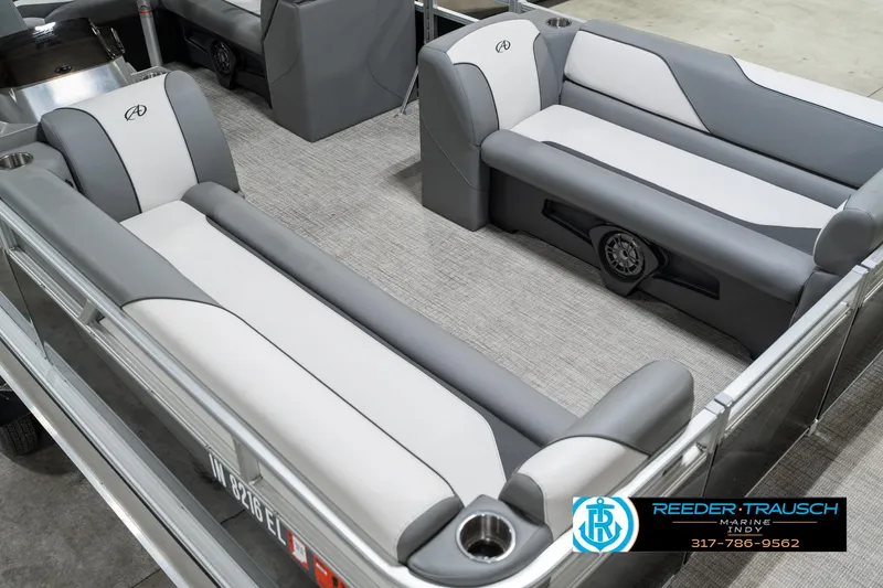 Slide: The Image of 2023 Avalon 2180 Vent CR boat interior with gray and white seating, cup holders, and speaker system. - 13