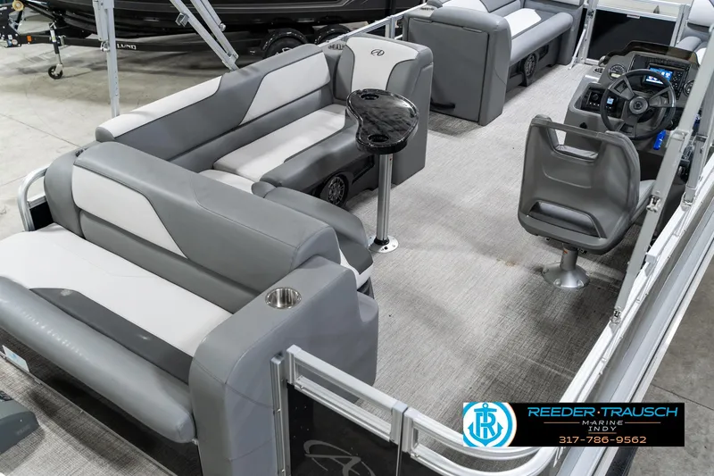 Slide: The Image of 2023 Avalon 2180 Vent CR pontoon boat interior with gray seating and modern dashboard. - 14