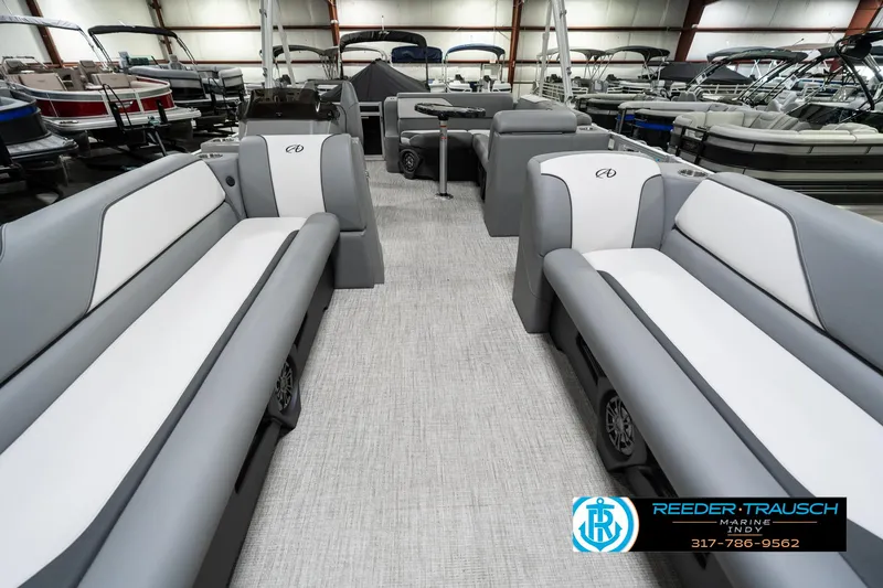 Slide: The Image of 2023 Avalon 2180 Vent CR pontoon boat interior with gray and white seating in showroom. - 16