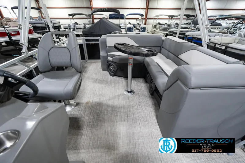 Slide: The Image of 2023 Avalon 2180 Vent CR pontoon boat interior with gray seating and table. - 17