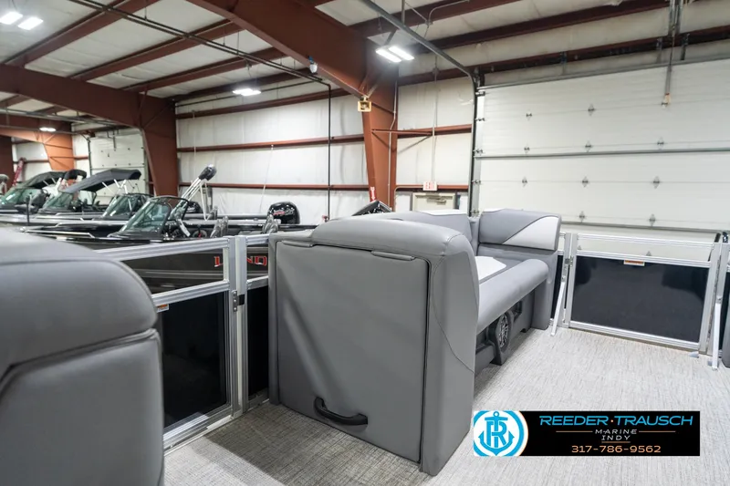 Slide: The Image of 2023 Avalon 2180 Vent CR pontoon boat interior in showroom with gray seating. - 23