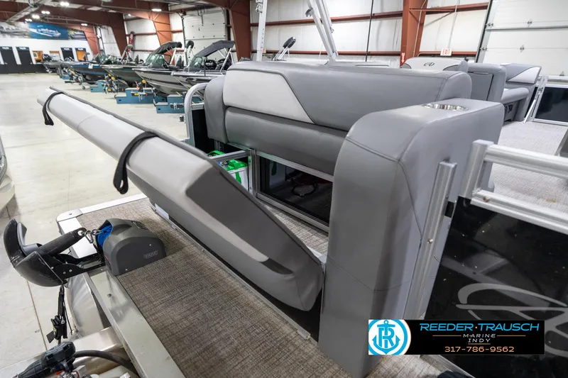 Slide: The Image of 2023 Avalon 2180 Vent CR pontoon boat interior with gray seating in showroom. - 30