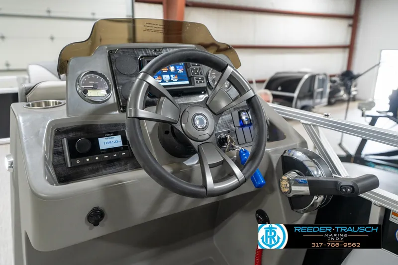 Slide: The Image of 2023 Avalon 2180 Vent CR boat dashboard with steering wheel and controls. - 32