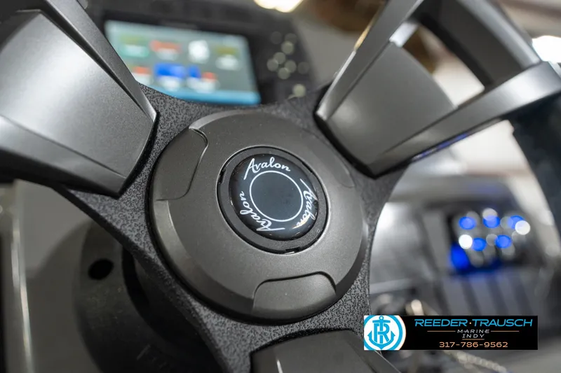 Slide: The Image of Close-up of 2023 Avalon 2180 Vent CR steering wheel with logo and dashboard in background. - 33
