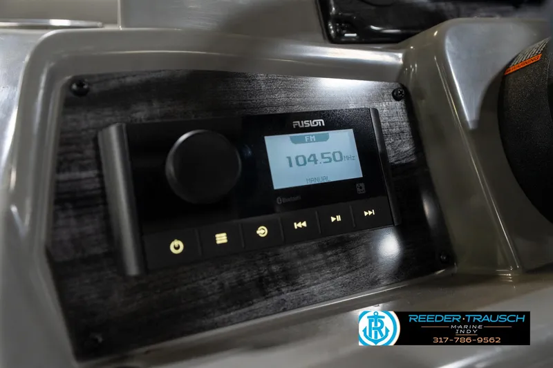 Slide: The Image of Close-up of 2023 Avalon 2180 Vent CR boat stereo system displaying FM 104.50 MHz. - 34