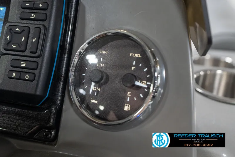 Slide: The Image of Control panel of 2023 Avalon 2180 Vent CR boat, featuring trim and fuel gauges. - 37