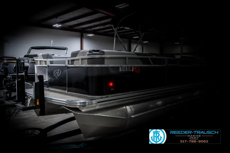 Slide: The Image of 2023 Avalon 2180 Vent CR pontoon boat in a dimly lit showroom. - 4