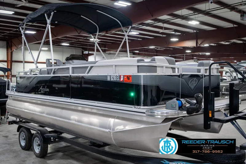 Slide: The Image of 2023 Avalon 2180 Vent CR pontoon boat in showroom, featuring sleek design and canopy. - 6