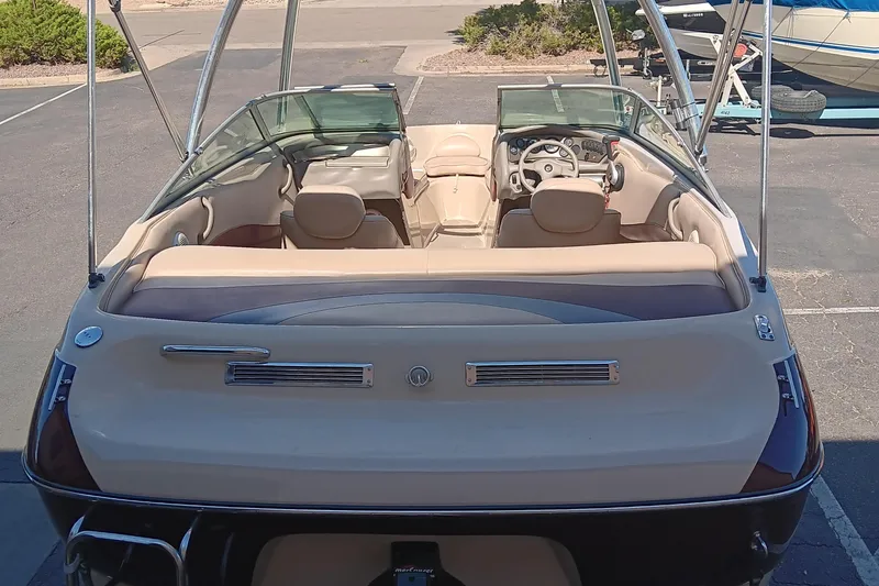 Slide: The Image of 1998 Crownline 192 BR DLX boat interior with beige seating and steering wheel. - 2