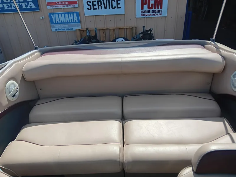 Slide: The Image of 1998 Crownline 192 BR DLX boat interior with beige seating and service signs in the background. - 4