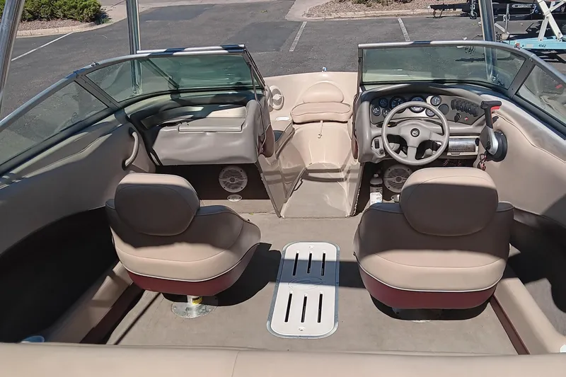 Slide: The Image of 1998 Crownline 192 BR DLX boat interior with beige seating and steering wheel. - 5
