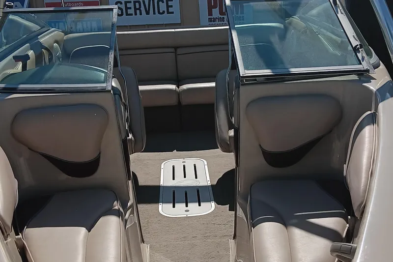 Slide: The Image of 1998 Crownline 192 BR DLX boat interior with beige seating and windshield. - 6
