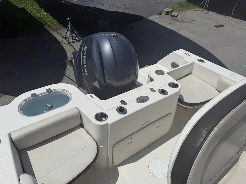 Slide: The Image of 2023 Sailfish 220 boat interior with Yamaha engine, featuring seating and control panel. - 13