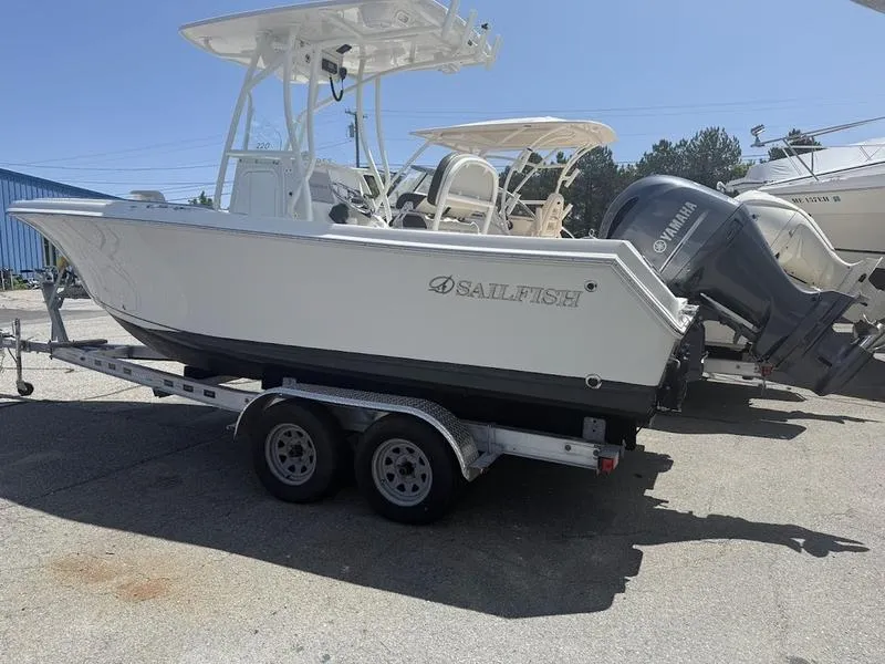 Slide: The Image of 2023 Sailfish 220 boat on trailer with Yamaha outboard motor, parked outdoors. - 3