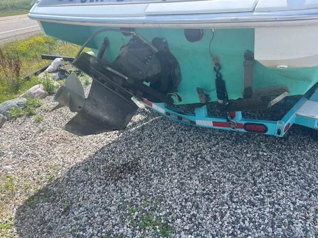 Slide: The Image of 1996 Formula 232 LS boat on gravel, showing propeller and trailer. - 2