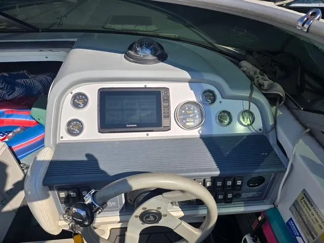 Slide: The Image of Dashboard of a 1996 Formula 232 LS boat with navigation equipment and steering wheel. - 7