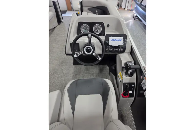Slide: The Image of 2026 Barletta Aria A20L boat dashboard with steering wheel and Lowrance display. - 11