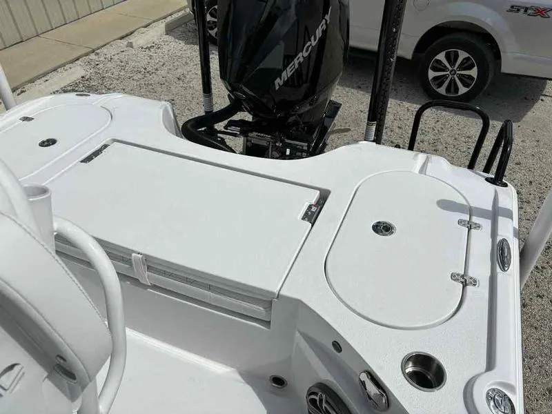 Slide: The Image of 2026 Blazer 2440 boat deck with Mercury engine, featuring storage compartments and seating. - 12