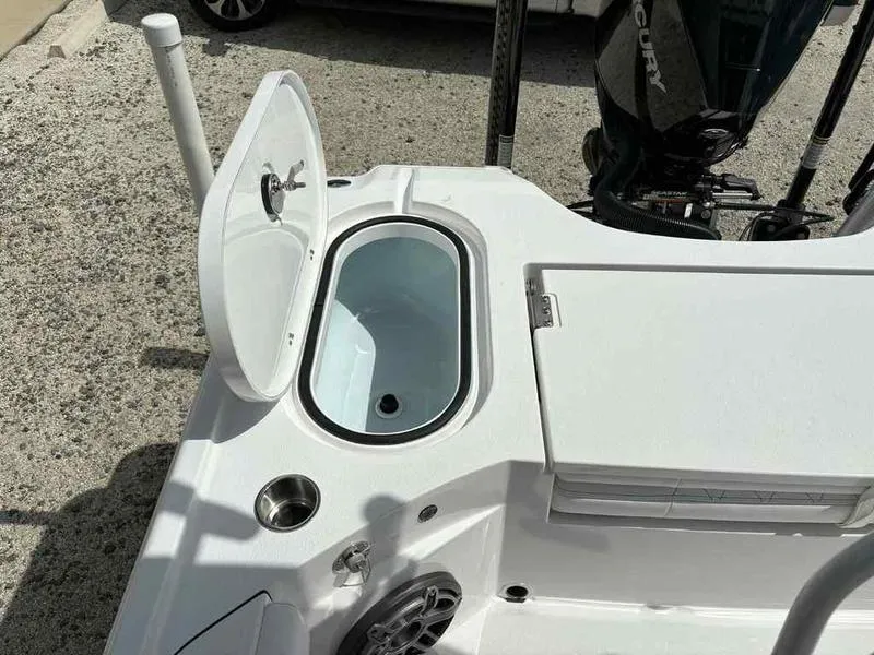 Slide: The Image of Open storage compartment on a 2026 Blazer 2440 boat, featuring a sleek white design. - 19