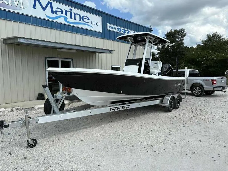 Slide: The Image of 2026 Blazer 2440 boat on trailer outside marine dealership. - 4
