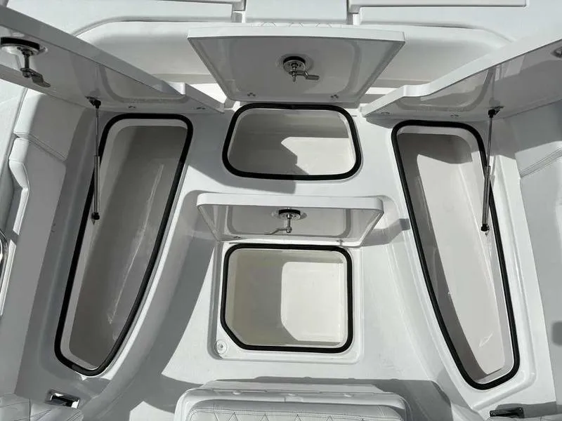 Slide: The Image of Open storage compartments on a 2026 Blazer 2440 boat, showcasing spacious interior design. - 8
