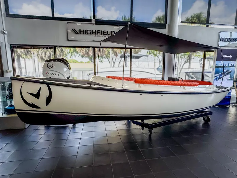 Slide: The Image of 2024 Vision Marine Technologies Fantail 217 electric boat displayed indoors. - 0