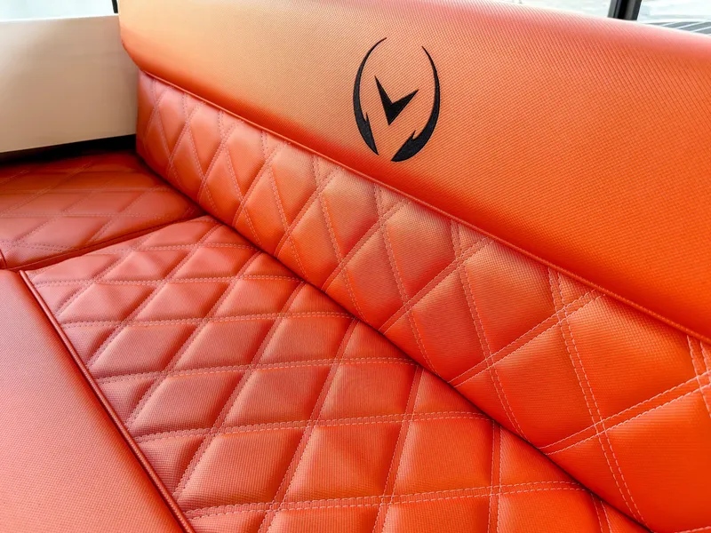 Slide: The Image of 2024 Vision Marine Technologies Fantail 217, orange quilted seating detail with logo. - 10