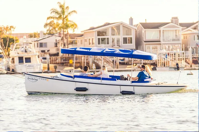 Slide: The Image of 2024 Vision Marine Technologies Fantail 217 boat cruising on a sunny waterfront. - 14