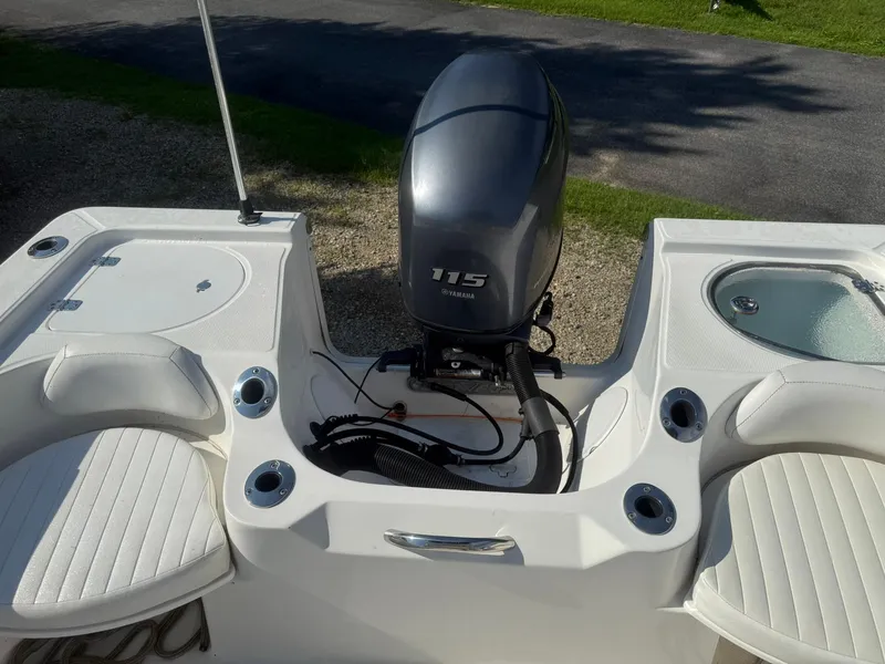 Slide: The Image of 2014 Sea Fox 199 Commander boat with Yamaha 115 engine, featuring seating and storage compartments. - 11