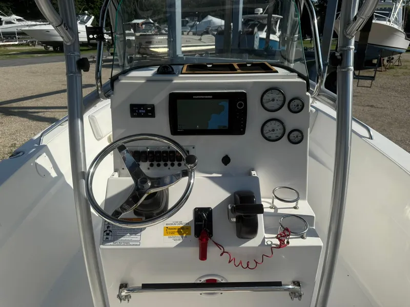 Slide: The Image of 2014 Sea Fox 199 Commander boat dashboard with steering wheel and navigation system. - 12