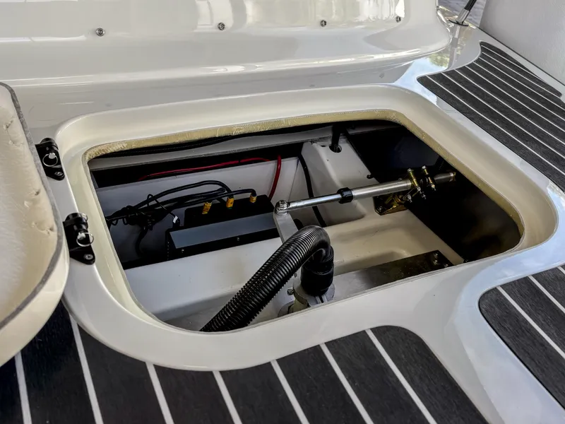 Slide: The Image of 2024 Vision Marine Technologies Fantail 217 boat interior compartment with visible wiring and components. - 3