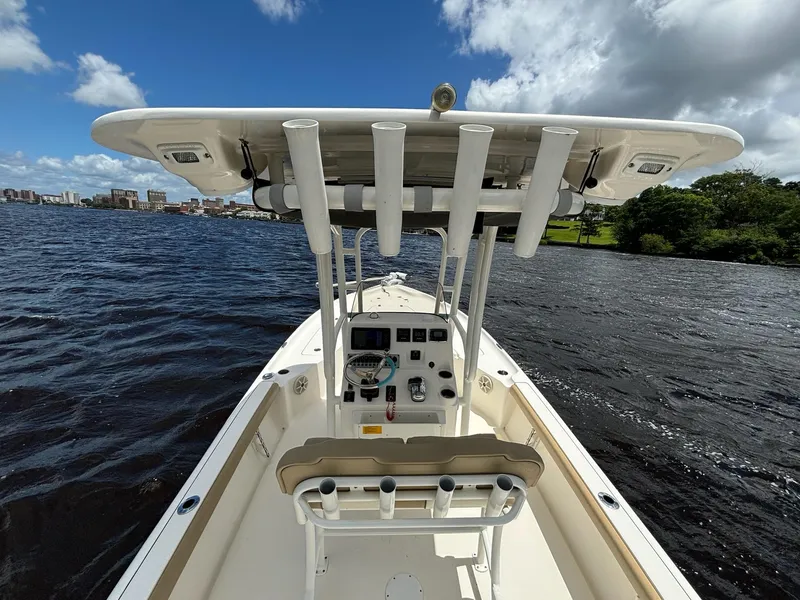 Slide: The Image of 2018 Key West 230 Bay Reef boat on water, clear sky, cityscape in background. - 5