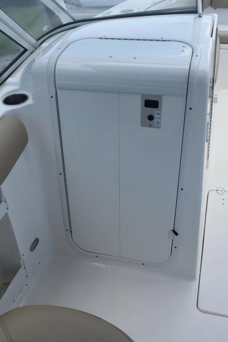 Slide: The Image of 2019 Key West 239 DFS boat interior with white panel and beige seating. - 12