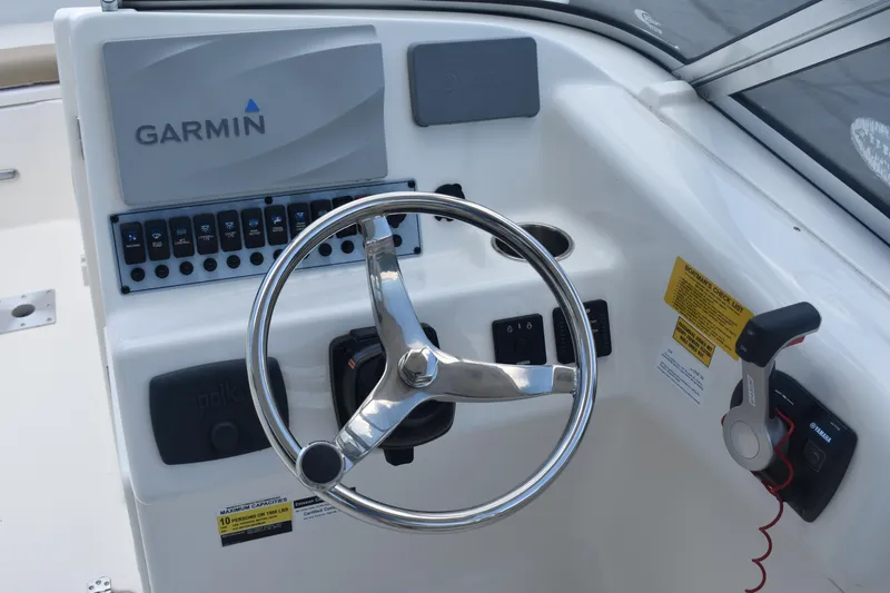 Slide: The Image of 2019 Key West 239 DFS boat dashboard with Garmin navigation system and steering wheel. - 14