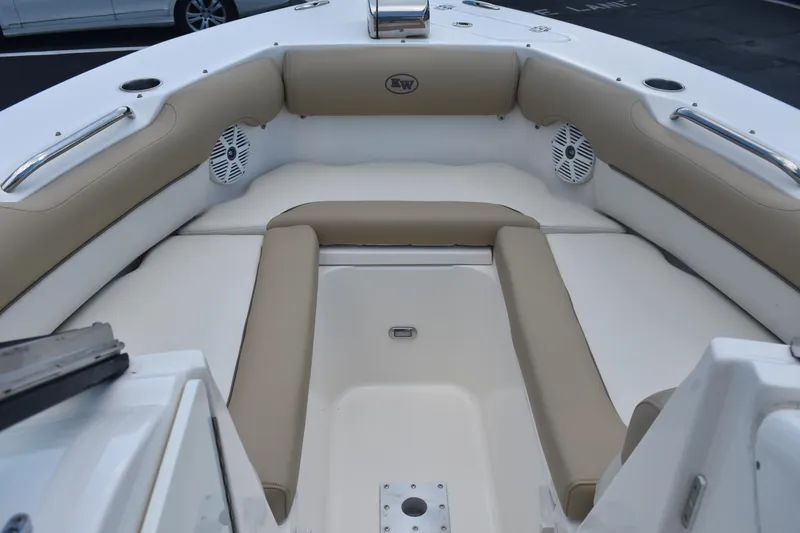 Slide: The Image of 2019 Key West 239 DFS boat interior with beige seating and speakers. - 17