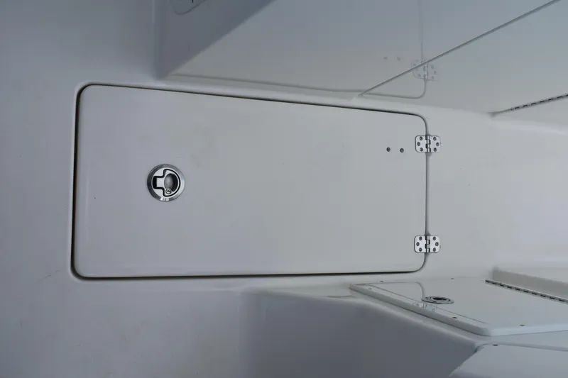 Slide: The Image of 2019 Key West 239 DFS boat storage compartment with secure latch and hinges. - 28