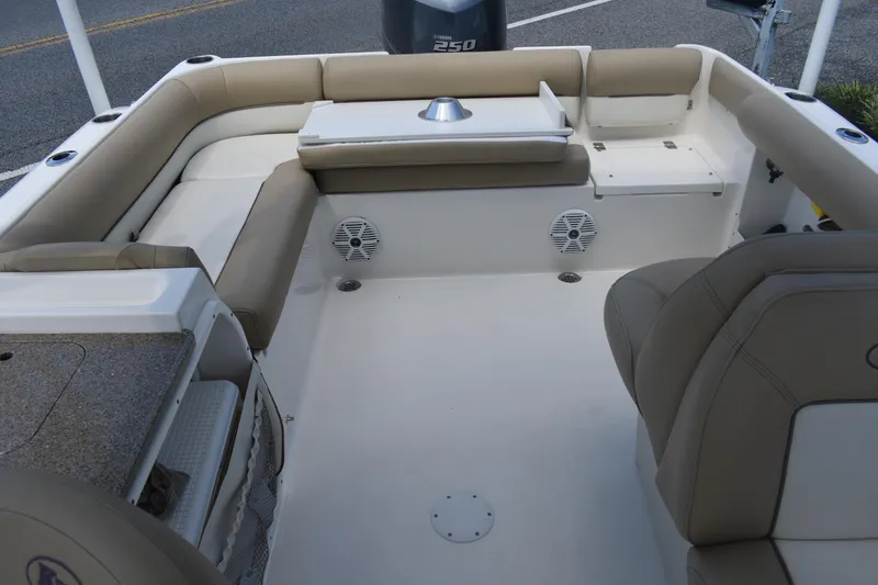 Slide: The Image of 2019 Key West 239 DFS boat interior with beige seating and table, showcasing spacious design. - 6