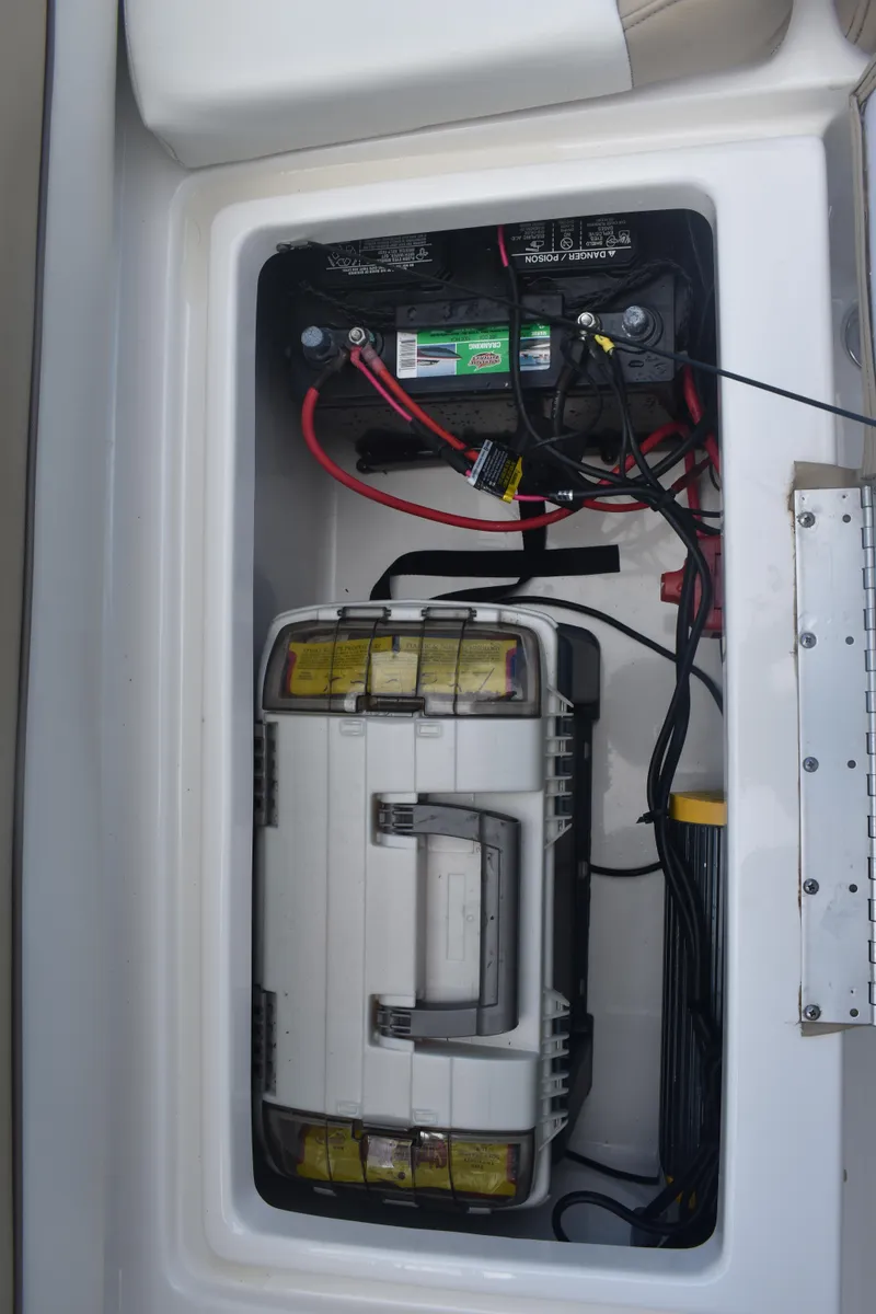 Slide: The Image of Battery compartment of 2019 Key West 239 DFS boat with wiring and storage box. - 9