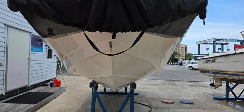 Slide: The Image of 2019 NauticStar 223DC Sport Deck boat on a stand at a marina. - 10